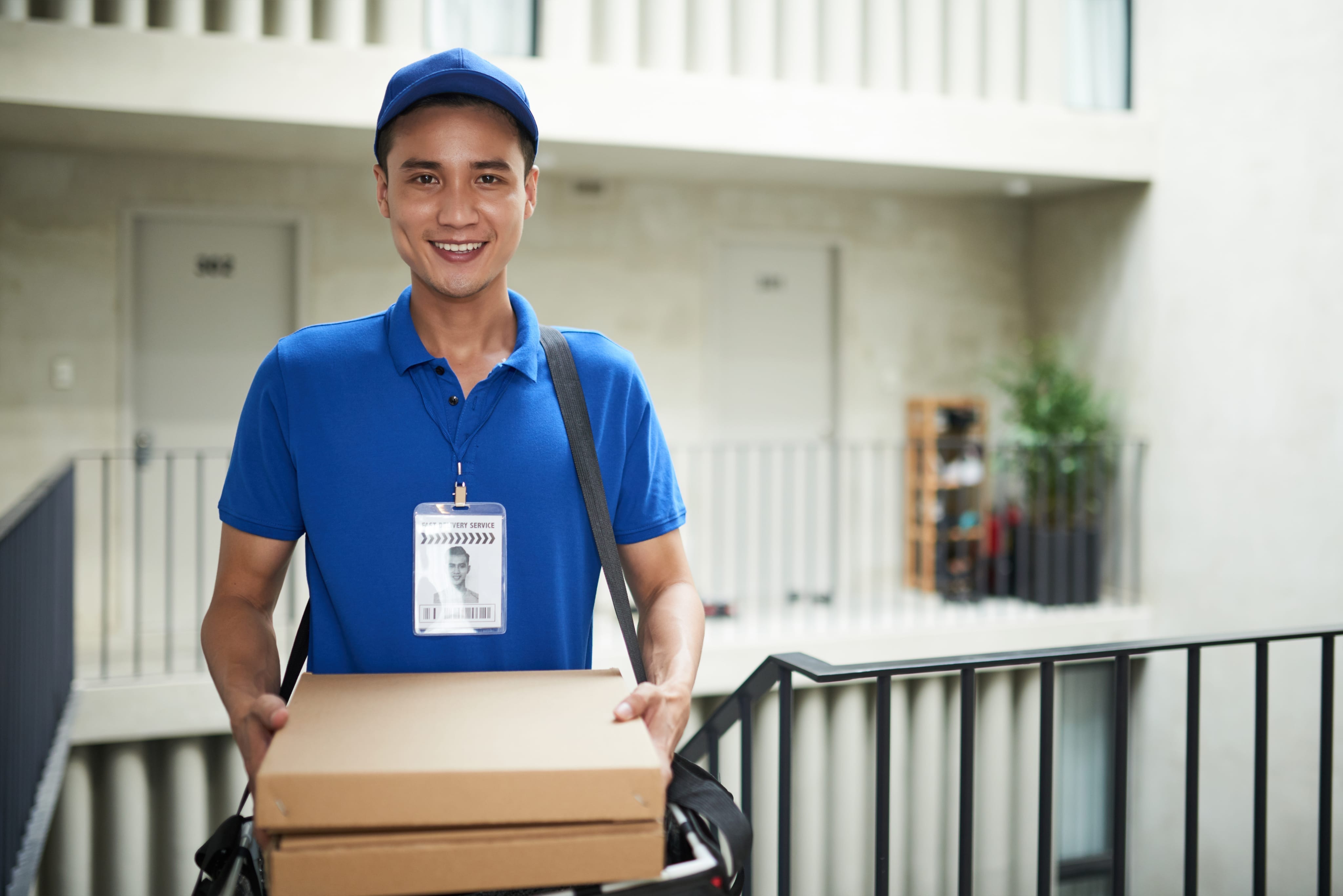 Delivery professional in uniform carrying packages